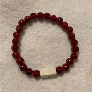 Red bracelet with accent piece